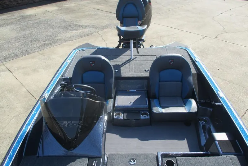 Slide: The Image of 2026 Triton 18 TrX boat interior with dual seats and steering console. - 6