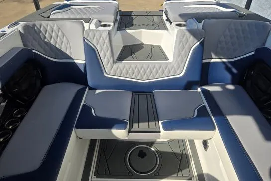 Slide: The Image of 2026 Tigé 22RZX boat interior with blue and gray seating, featuring diamond stitching. - 6