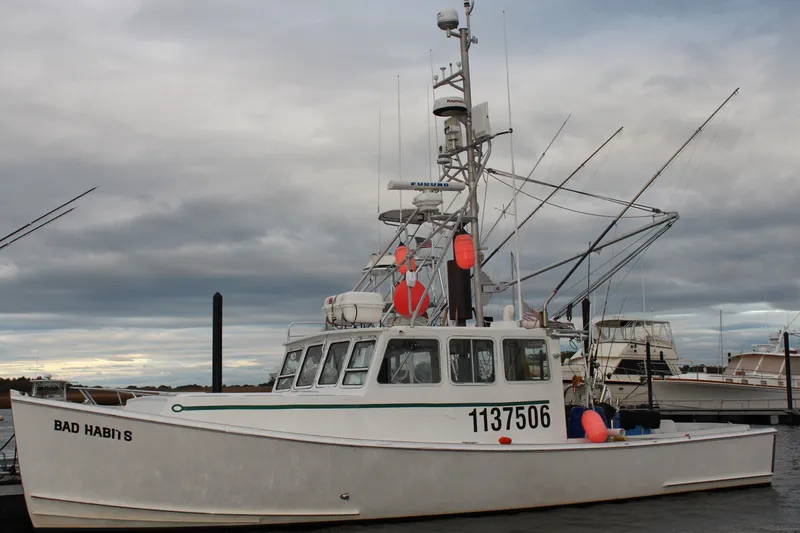The Image of 2002 Libby 38 Downeast fishing boat docked, named "Bad Habits," with fishing gear and buoys. - 0