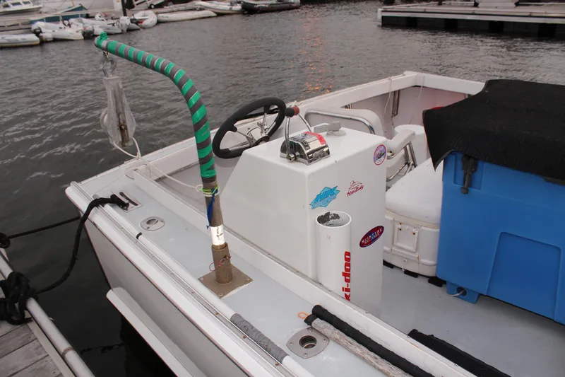 Slide: The Image of 2002 Libby 38 Downeast boat interior with steering console and docked at marina. - 10