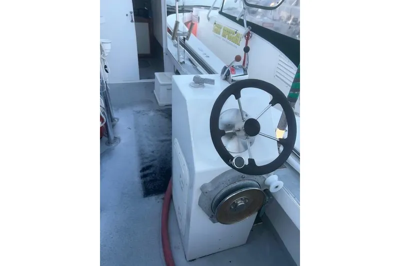 Slide: The Image of 2002 Libby 38 Downeast boat helm with steering wheel and controls. - 11