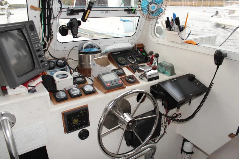 Slide: The Image of Helm of 2002 Libby 38 Downeast boat with navigation equipment and controls. - 14