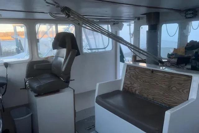 Slide: The Image of Interior of 2002 Libby 38 Downeast boat with seating and helm station. - 16