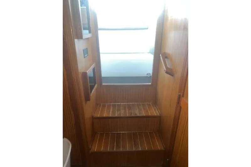 Slide: The Image of Wooden interior stairs of 2002 Libby 38 Downeast boat, leading to upper deck. - 20