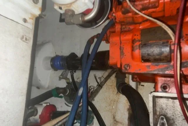 Slide: The Image of Engine compartment of a 2002 Libby 38 Downeast boat, showing mechanical components and hoses. - 29