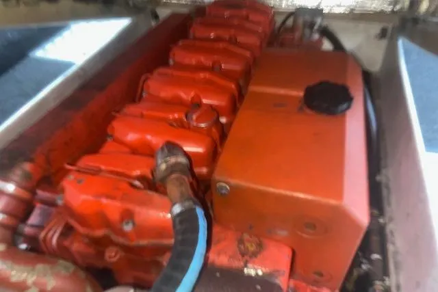 Slide: The Image of Engine compartment of a 2002 Libby 38 Downeast boat, featuring a red engine block. - 30