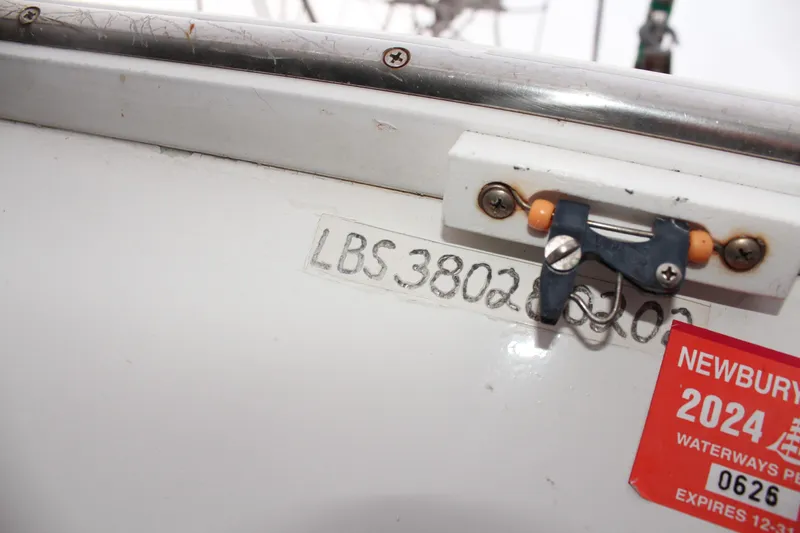 Slide: The Image of Close-up of a 2002 Libby 38 Downeast boat with registration details. - 36