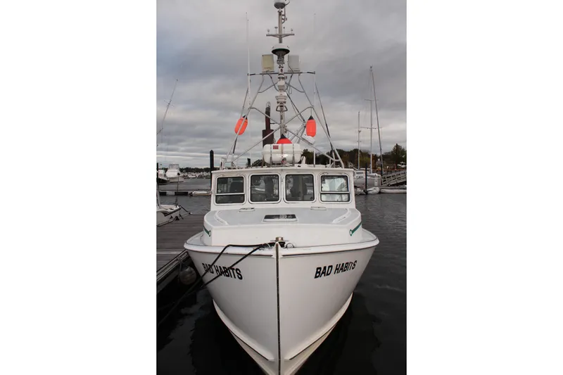 Slide: The Image of Front view of 2002 Libby 38 Downeast boat named "Bad Habits" docked at marina. - 5