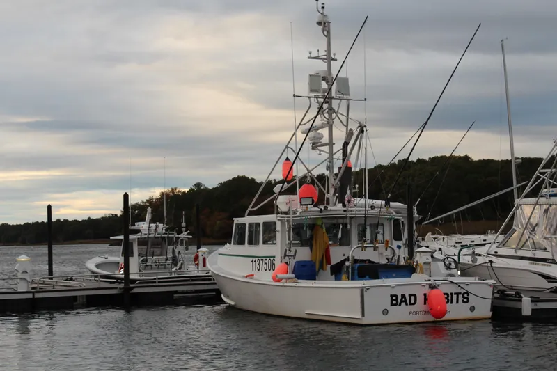 Slide: The Image of Libby 38 Downeast 2002 boat docked at marina under cloudy sky. - 7