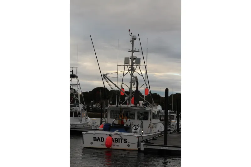 Slide: The Image of 2002 Libby 38 Downeast boat docked at marina under cloudy sky. - 8