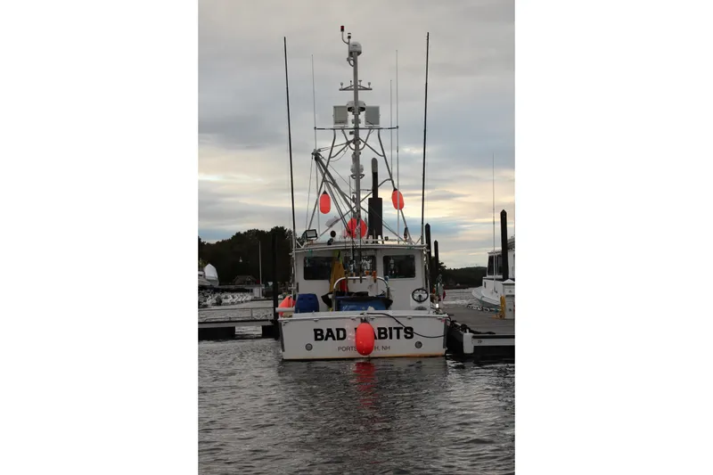 Slide: The Image of 2002 Libby 38 Downeast boat docked, rear view with buoys and antennas. - 9
