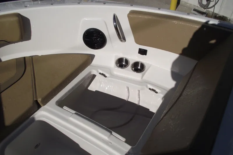 Slide: The Image of 2026 Bayliner V20 boat interior with tan seating and cup holders. - 11