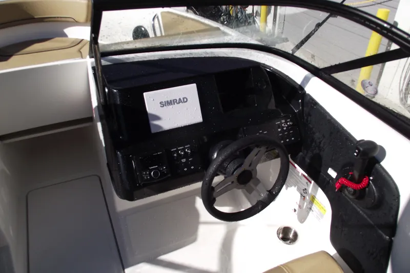 Slide: The Image of 2026 Bayliner V20 boat cockpit with Simrad navigation system and steering wheel. - 13