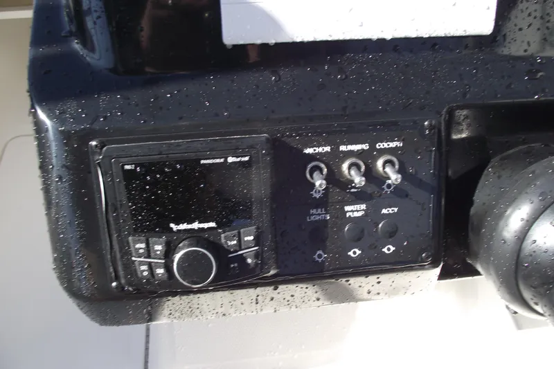 Slide: The Image of Control panel of 2026 Bayliner V20 boat with switches and audio system. - 14