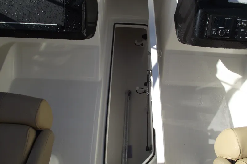 Slide: The Image of Interior view of 2026 Bayliner V20 boat with seating and storage compartment. - 20