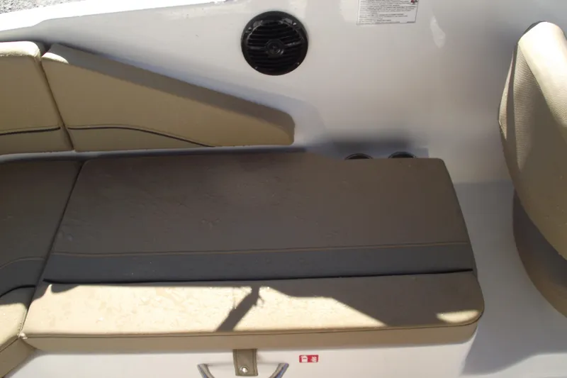 Slide: The Image of 2026 Bayliner V20 boat interior with beige seating and speaker. - 24