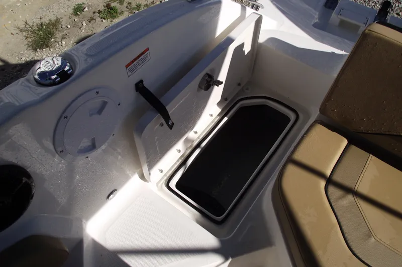 Slide: The Image of 2026 Bayliner V20 boat interior storage compartment with beige seating. - 31