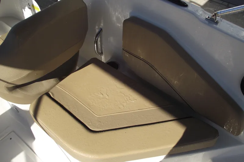 Slide: The Image of 2026 Bayliner V20 boat interior with tan seating and sleek design. - 32