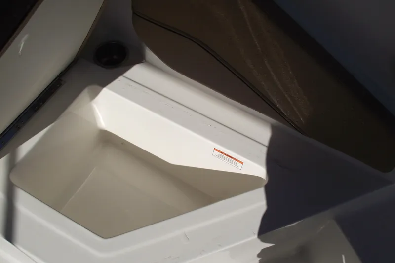 Slide: The Image of 2026 Bayliner V20 boat interior storage compartment with shadowed seating area. - 33