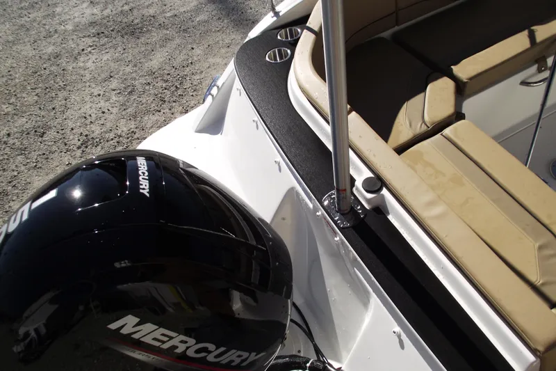 Slide: The Image of 2026 Bayliner V20 boat with Mercury engine and beige seating. - 34