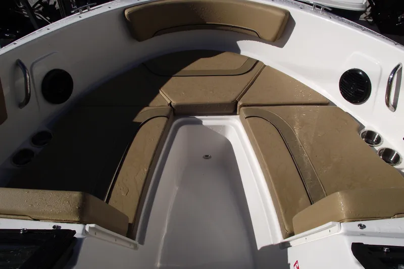 Slide: The Image of 2026 Bayliner V20 boat interior with tan seating and cup holders. - 7