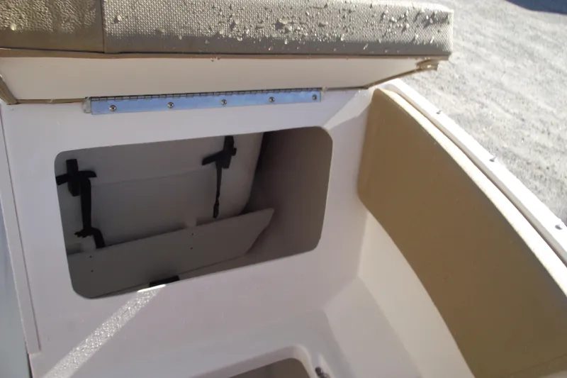 Slide: The Image of 2026 Bayliner V20 boat storage compartment with cushioned seating. - 8