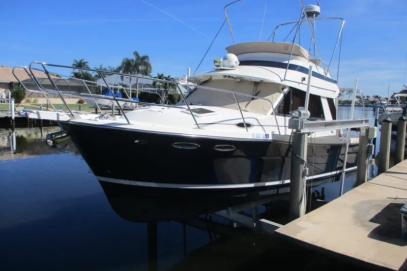 The Image of 2015 Cutwater 30 Command Bridge LE boat docked in sunny marina. - 0