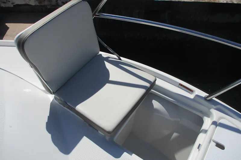 Slide: The Image of 2015 Cutwater 30 Command Bridge LE boat seat with white cushion and railing. - 10