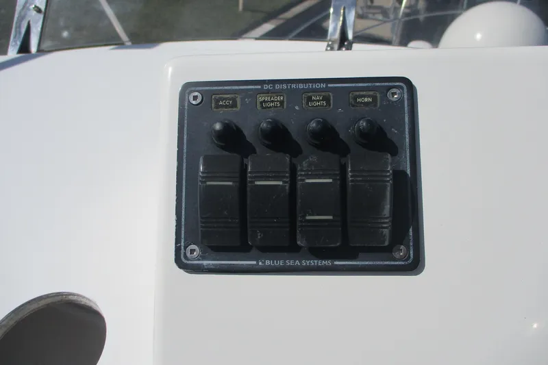 Slide: The Image of Control panel on 2015 Cutwater 30 Command Bridge LE boat, featuring switches for lights and horn. - 17