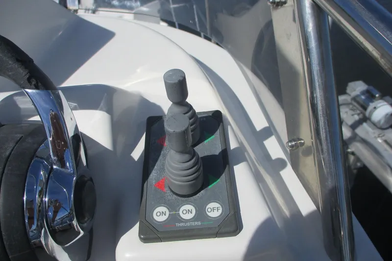 Slide: The Image of Control panel of 2015 Cutwater 30 Command Bridge LE boat with joystick and buttons. - 18