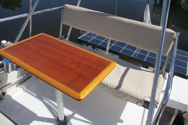 Slide: The Image of Cutwater 30 Command Bridge LE 2015 boat with wooden table and cushioned seating. - 20