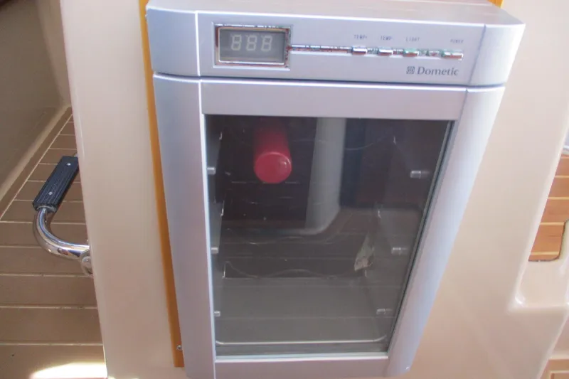 Slide: The Image of Dometic fridge on 2015 Cutwater 30 Command Bridge LE boat interior. - 26