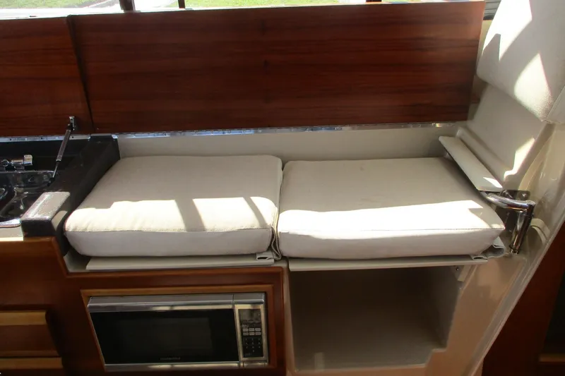 Slide: The Image of Interior of 2015 Cutwater 30 Command Bridge LE with cushioned seating and microwave. - 33