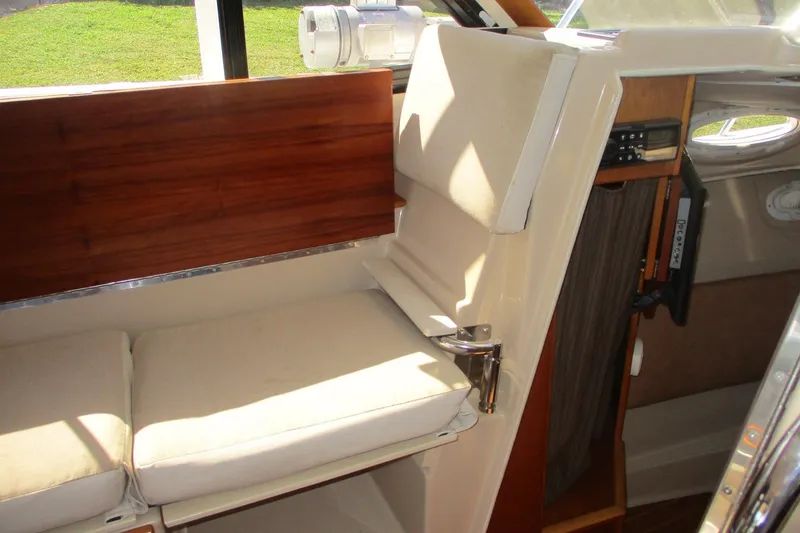 Slide: The Image of Interior of 2015 Cutwater 30 Command Bridge LE, featuring cushioned seating and wooden accents. - 34