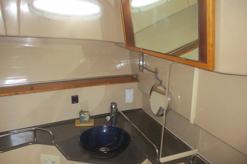 Slide: The Image of 2015 Cutwater 30 Command Bridge LE bathroom with modern sink and mirror. - 38