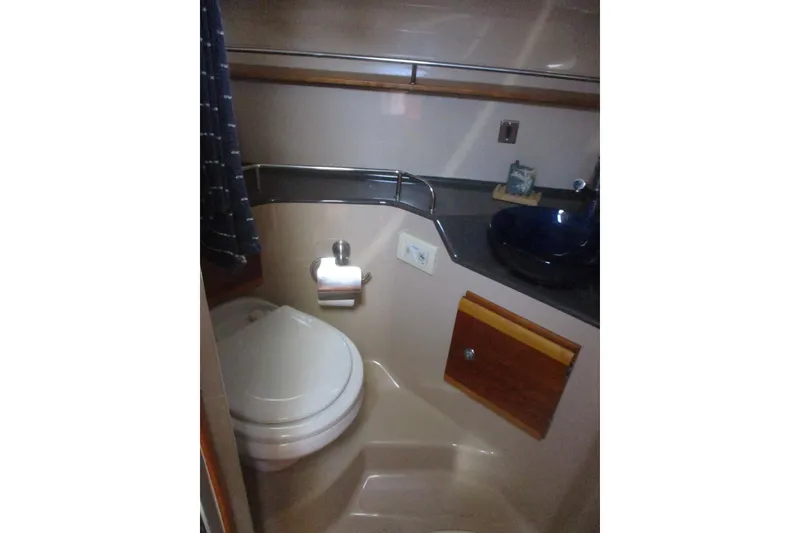 Slide: The Image of Compact bathroom in 2015 Cutwater 30 Command Bridge LE boat, featuring toilet and sink. - 39