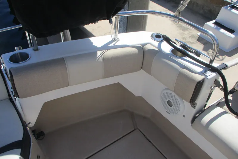 Slide: The Image of 2015 Cutwater 30 Command Bridge LE boat seating area with cup holders and speaker. - 4