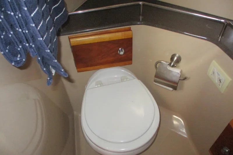 Slide: The Image of Bathroom interior of 2015 Cutwater 30 Command Bridge LE boat, featuring toilet and towel. - 41