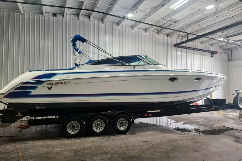 The Image of 1997 Formula 330 Sun Sport boat on trailer in indoor storage facility. - 0