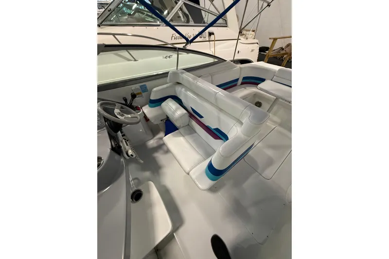 Slide: The Image of 1997 Formula 330 Sun Sport boat interior with colorful seating and open cabin door. - 18