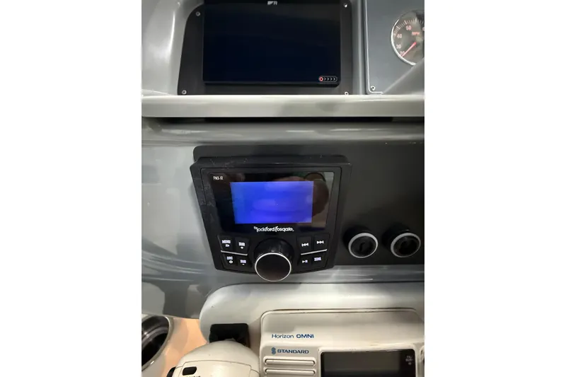 Slide: The Image of 1997 Formula 330 Sun Sport dashboard with Rockford Fosgate audio system and navigation controls. - 23