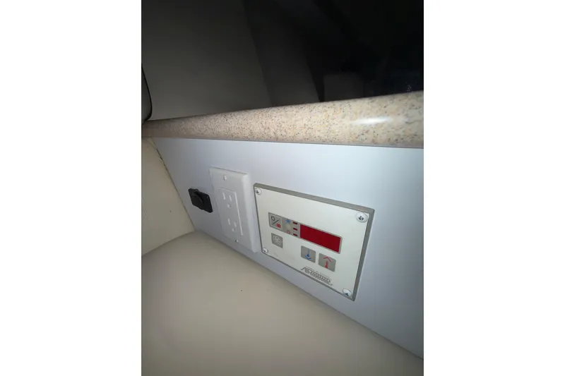 Slide: The Image of 1997 Formula 330 Sun Sport boat bathroom with sink, toilet, and porthole windows. - 30