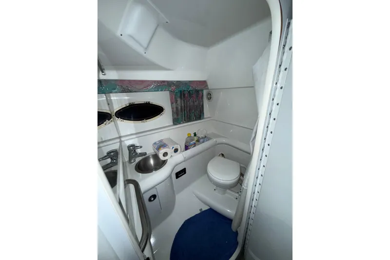 Slide: The Image of Interior of 1997 Formula 330 Sun Sport boat with beige seating and blue cover. - 31