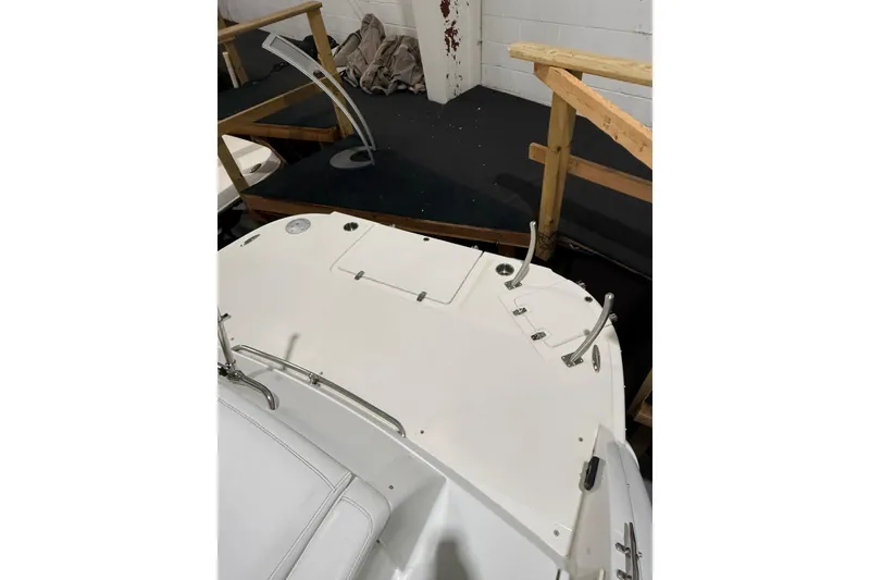 Slide: The Image of 1997 Formula 330 Sun Sport boat with blue canopy in indoor storage. - 8