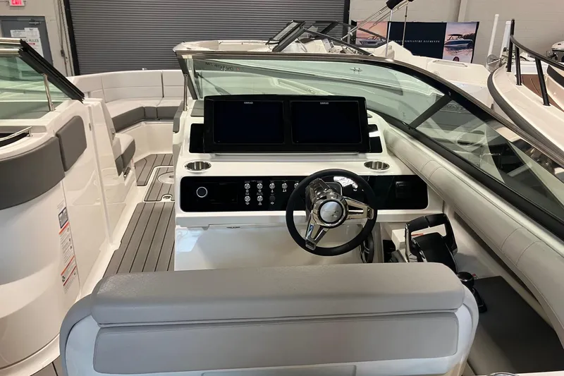 Slide: The Image of 2026 Sea Ray SLX 310 Outboard boat interior with modern dashboard and seating. - 10