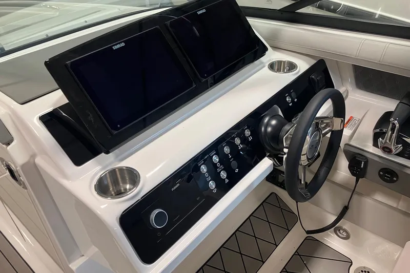 Slide: The Image of 2026 Sea Ray SLX 310 Outboard helm with dual Simrad displays and modern controls. - 11