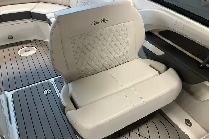 Slide: The Image of 2026 Sea Ray SLX 310 Outboard interior with luxurious seating and sleek flooring. - 15