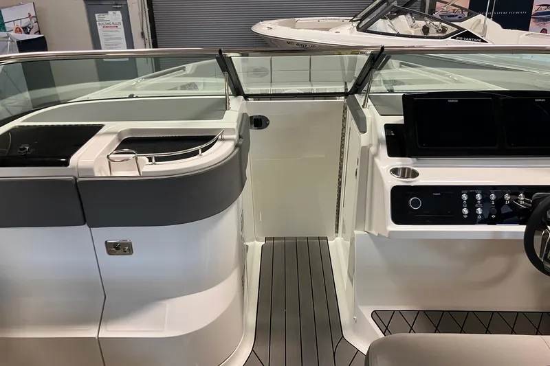 Slide: The Image of 2026 Sea Ray SLX 310 Outboard boat interior with modern dashboard and sleek design. - 16