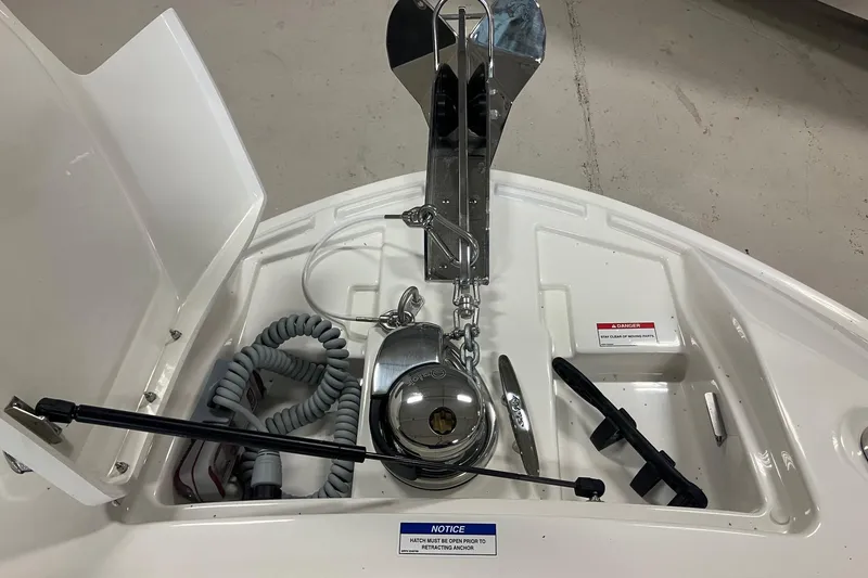 Slide: The Image of Anchor compartment of 2026 Sea Ray SLX 310 Outboard, featuring winch and storage. - 20