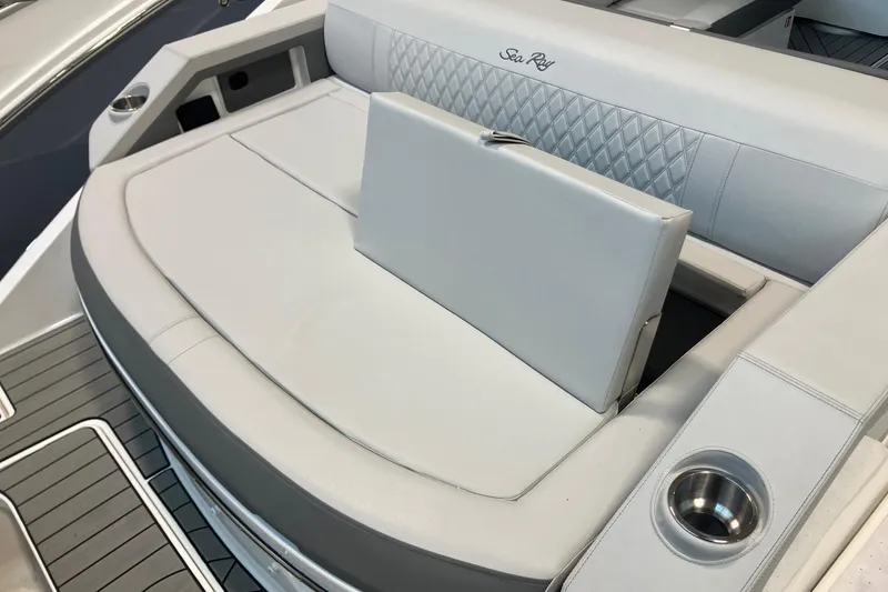 Slide: The Image of 2026 Sea Ray SLX 310 Outboard boat seating with elegant white upholstery and cup holder. - 4